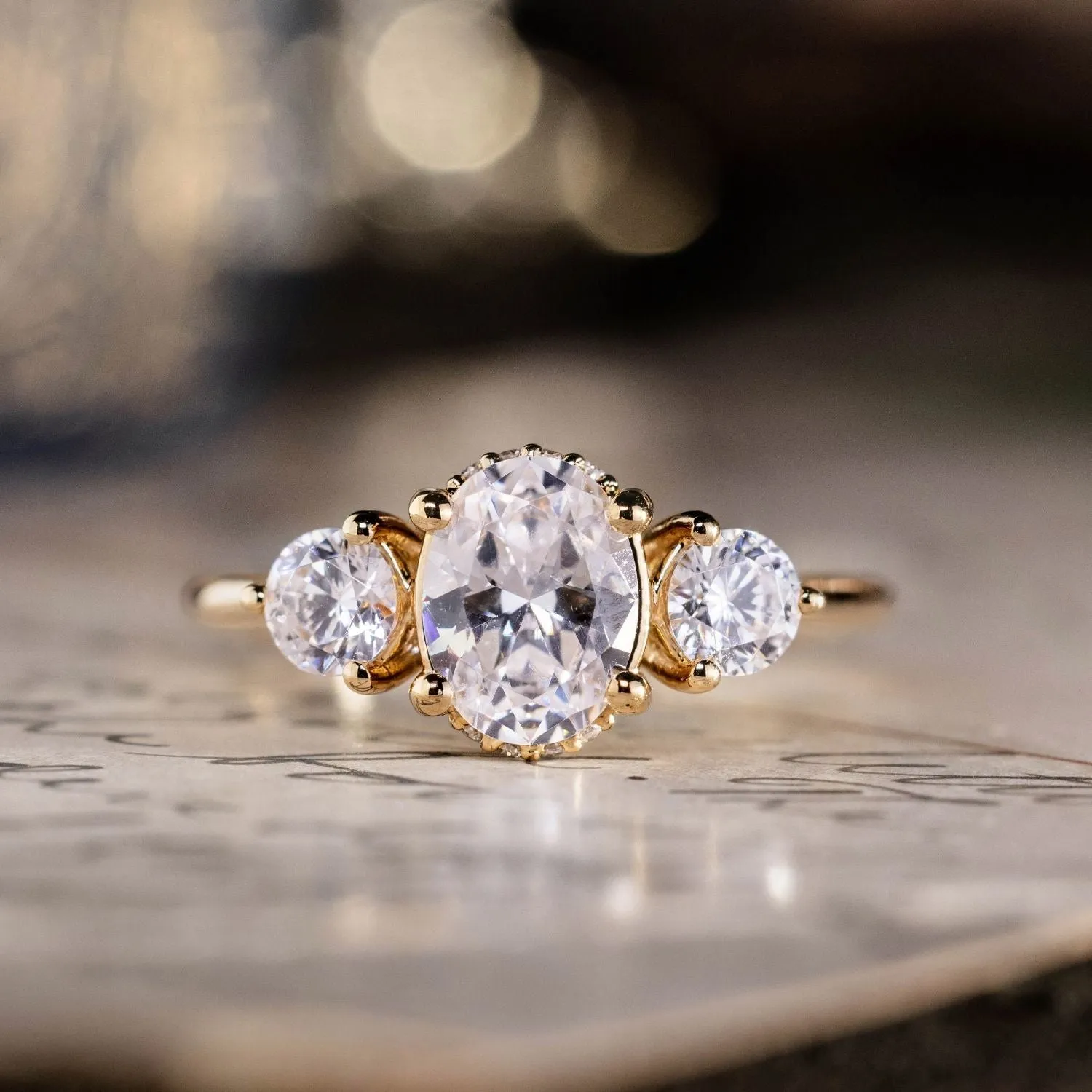 The Wren - Oval Diamond Three Stone Engagement Ring with Round Diamond Accents