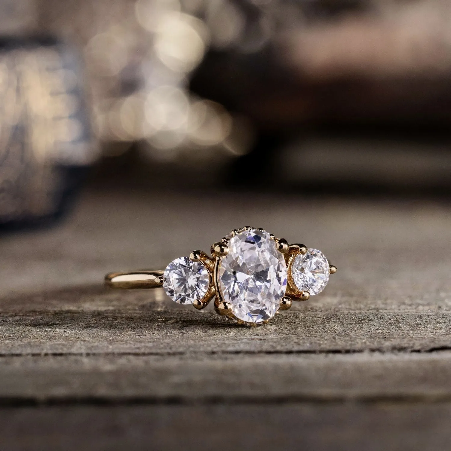 The Wren - Oval Diamond Three Stone Engagement Ring with Round Diamond Accents
