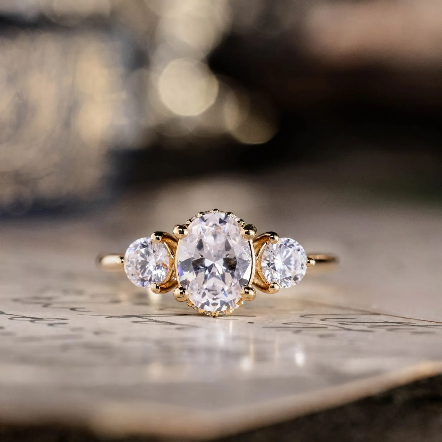 The Wren - Oval Diamond Three Stone Engagement Ring with Round Diamond Accents